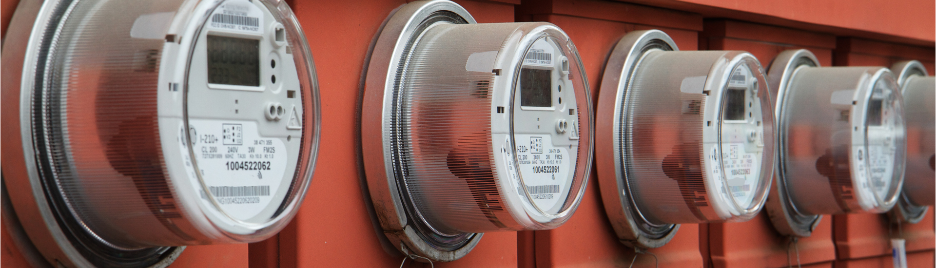 Electric Power Meters on Red Electrical Panels